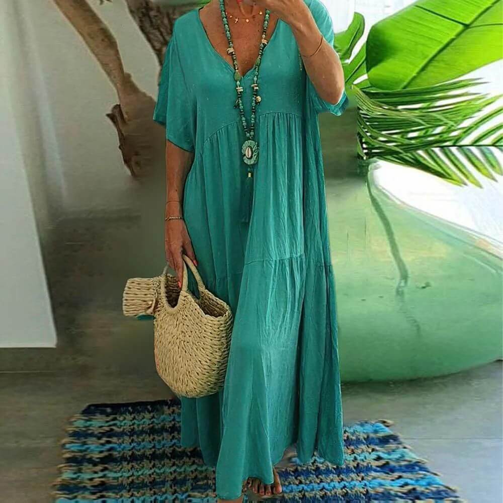 Türkises Coraline Sommerkleid, mit luftigen Stoff und frischer Farbe perfekt für entspannte Sommertage und Events.